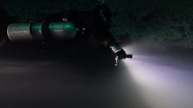 technical diver dives very close to a halocline in a cave dive in Mexico