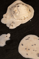 creamy ice cream with pieces of chocolate on a black slate