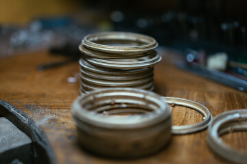 Front view of a set of various tools placed on a wooden desk in a workshop