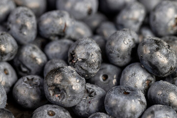a pile of blueberries scattered on the board