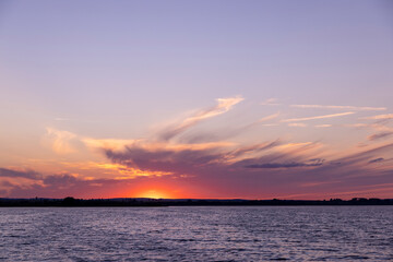 beautiful bright sunset on the lake in the summer