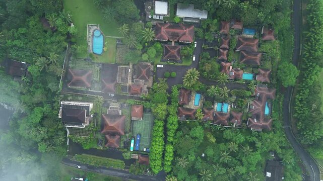 Aerial View of a Villa with a swimming pool on a Plateau Surrounded by trees