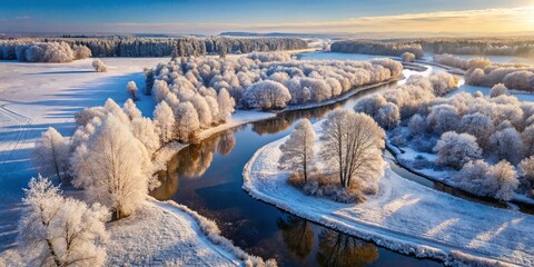 Aerial View of Frosty Winter Woodland with Trees, Riverbank, Small Creek, and Snow-Covered Fields