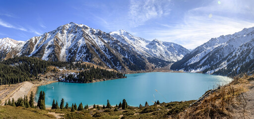 Beautiful mountain lake with ice and snow. Big Almaty lake in winter time. Kazakhstan.