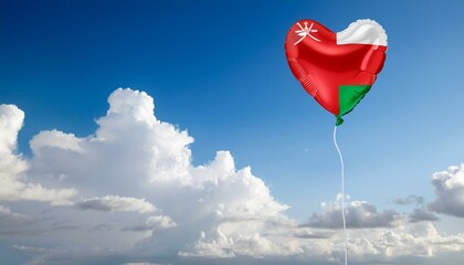Fototapeta premium オマーンの国旗のハート型の風船と青空(Oman flag heart-shaped balloon and blue sky.) 