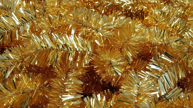 Golden tinsel garland, a classic Christmas decoration, is ready to adorn a tree or mantle