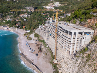 Drone photo of a large abandoned hotel at the coast in Montenegro