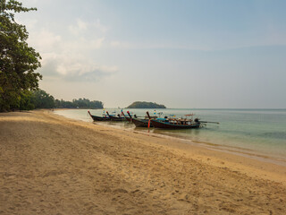 Fototapeta premium Traditional Long-tailed boats moored on the beach in the Krabi Province