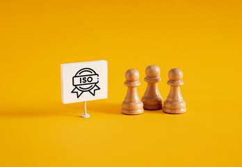  Chess pawns near a banner with iso international organization for standardization symbol.