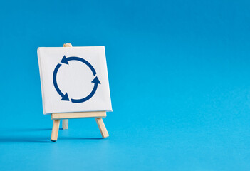 Easel with rotating arrows symbol