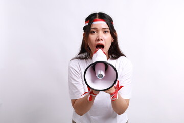 A portrait of an Asian woman wearing red white flag ribbon, announcing something while holding a megaphone, isolated on a white background, celebrate Indonesia independence day