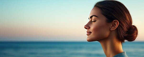 Obraz premium Woman relaxing peacefully by the ocean at sunset, serene and tranquil atmosphere.