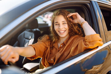 Happy woman driving a car.  Car travel, lifestyle concept.