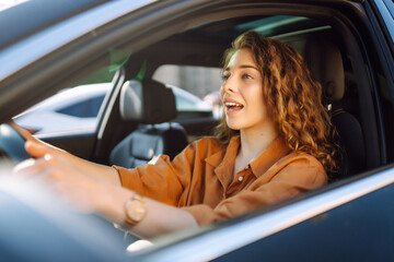 Happy woman driving a car.  Car travel, lifestyle concept.