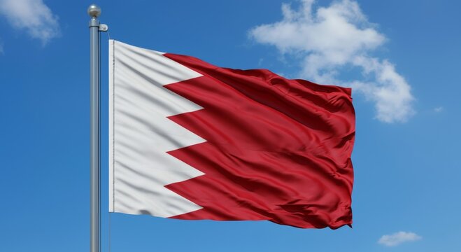 Bahrain national flag waving against a clear blue sky with clouds.