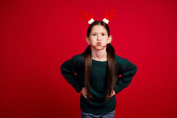 Portrait of lovely small girl pouted cheeks hold breath empty space wear sweater new year xmas...