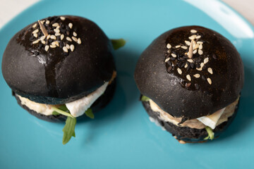 Mini Black Burger with Sesame Seeds, tasty cheeseburger with grilled beef, restaurant menu snack for eating