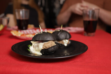 Mini Black Burger with Sesame Seeds, tasty slider snack with beef and bun, restaurant menu meal for lunch