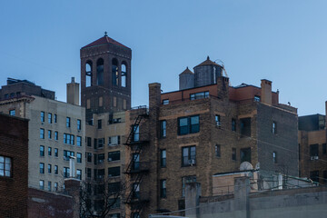 Fototapeta premium Low angle view of old brick buildings against sky in Midtown of Manhattan