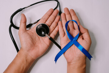 Stethoscope and blue ribbon isolated on a white background, symbolizing World Diabetes Day and health awareness in a clean, minimalist composition