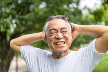 Sick unhappy senior elderly man touching head serious depressed feeling headache thinking of...