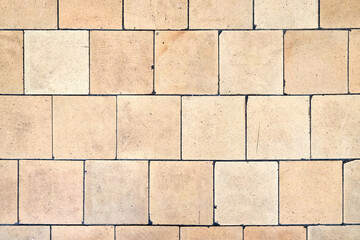 Orange brown white beige old shabby worn out floor tiles with damages cracks dirt caverns potholes...