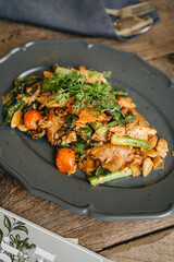 A plate of Thai flat noodles with chicken