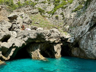 Blue grotto with three natural caves in the side of a rock formation in Capri, Italy