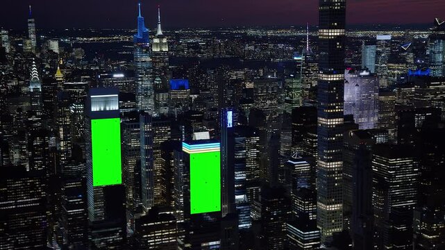 Top Aerial View of New York City Skyscrapers with Green Screen Billboards and tracking points. Aerial Modern City at Night. Manhattan Chroma Key.