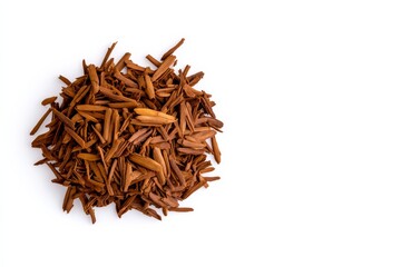 Pile of wood chips on a white background. The wood chips are brown and scattered around the pile. rooibos light flight on a white background