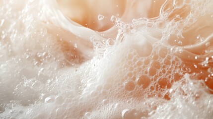 Fototapeta premium A close-up shot of soap suds with many bubbles and drops. The foam looks airy and delicate, with fine bubble details and subtle play of light creating a soft, soothing mood.