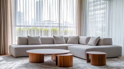 Fototapeta premium A contemporary living room features an L-shaped sofa and circular tables, with large windows overlooking a bustling cityscape.
