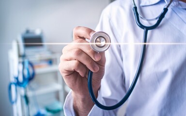 A doctor holds a stethoscope with a beam of light emanating from it.