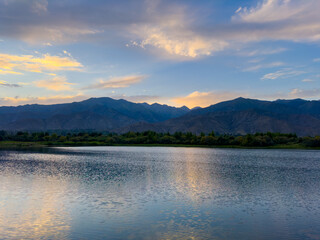 A quiet mountain lake Issyk-Kul, surrounded by green valleys and majestic mountains. The perfect spot for tourism and peaceful relaxation in Kyrgyzstan.