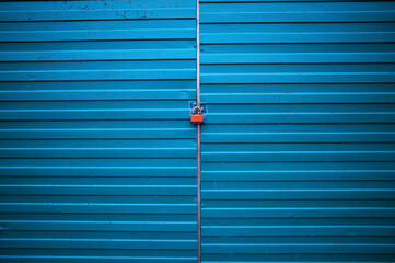 Closed blue garage doors with red lock texture background