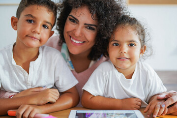 Portrait of nanny and children using digital tablet indoor - Home schooling and day care concept