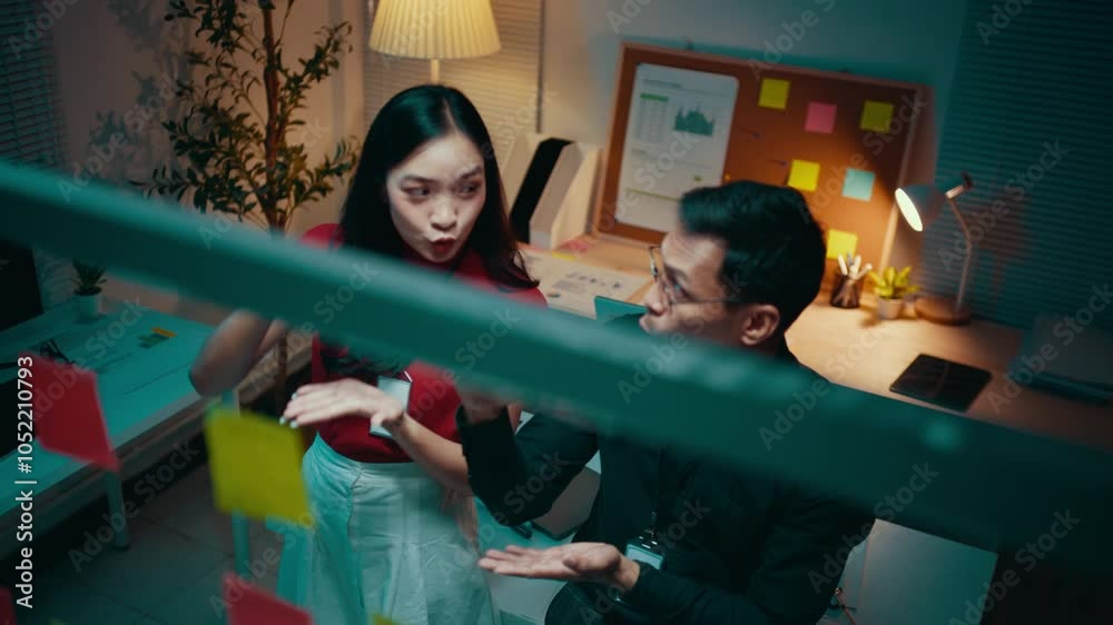 Poster two business partners are having a discussion in their office at night. they are using sticky notes 