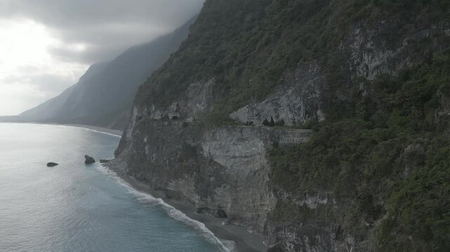 Drone footage of Taroko Gorge mountains overlooking the sea on an overcast day in Taiwan