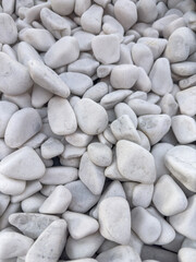 a white small pebbles stone as  background rock texture