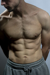 A young shirtless muscluar man