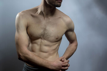 A young shirtless muscluar man