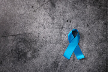 Top view of  blue ribbon international symbol on abstract dark background.