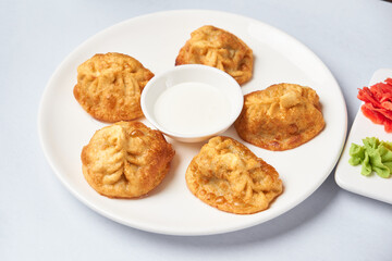 fried manty uzbek cuisine on wooden background top view