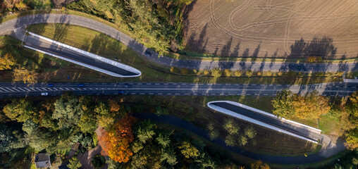 Autumn aerial top down view of bike path tunnel underneath motorway. Graphic panorama Dutch...