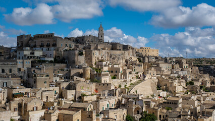 Naklejka premium Exploring the ancient charm of Matera in Puglia, Italy, under a picturesque cloudy sky