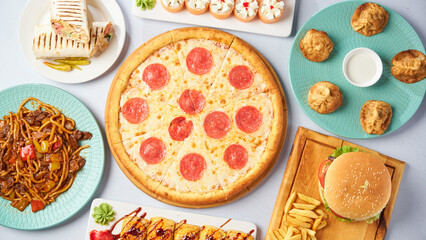 Different dishes - pizza, burger, manti, lagman, doner, sushi. Top view on a light background