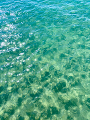 Fototapeta premium Texture of blue calm water creates a serene and peaceful background. The natural beauty of water reflects the essence of nature, evoking a sense of tranquility reminiscent of the sea.