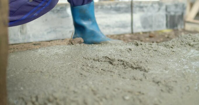 Spread the cement with Plastering trovel.Hand Holding Trowel and Smoothing Out the Plastering Concrete.Pouring cement for smooth areas.Cement flooring instead of ground.	