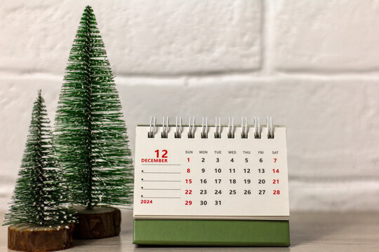 The calendar shows December 2024. Desk flip calendar. Hello, December.