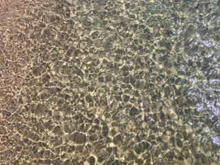 Texture of blue calm water creates a serene and peaceful background. The natural beauty of water reflects the essence of nature, evoking a sense of tranquility reminiscent of the sea.